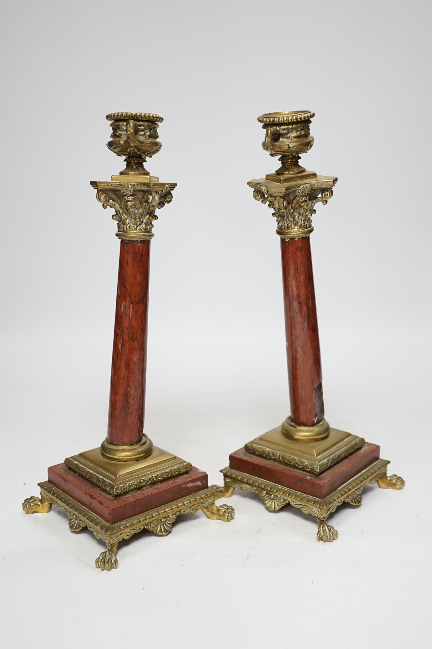 A pair of 19th century brass mounted rouge marble candlesticks, 29cm (a.f.)